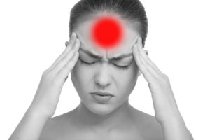 Beautiful young woman with headache touching her temples, isolated in white